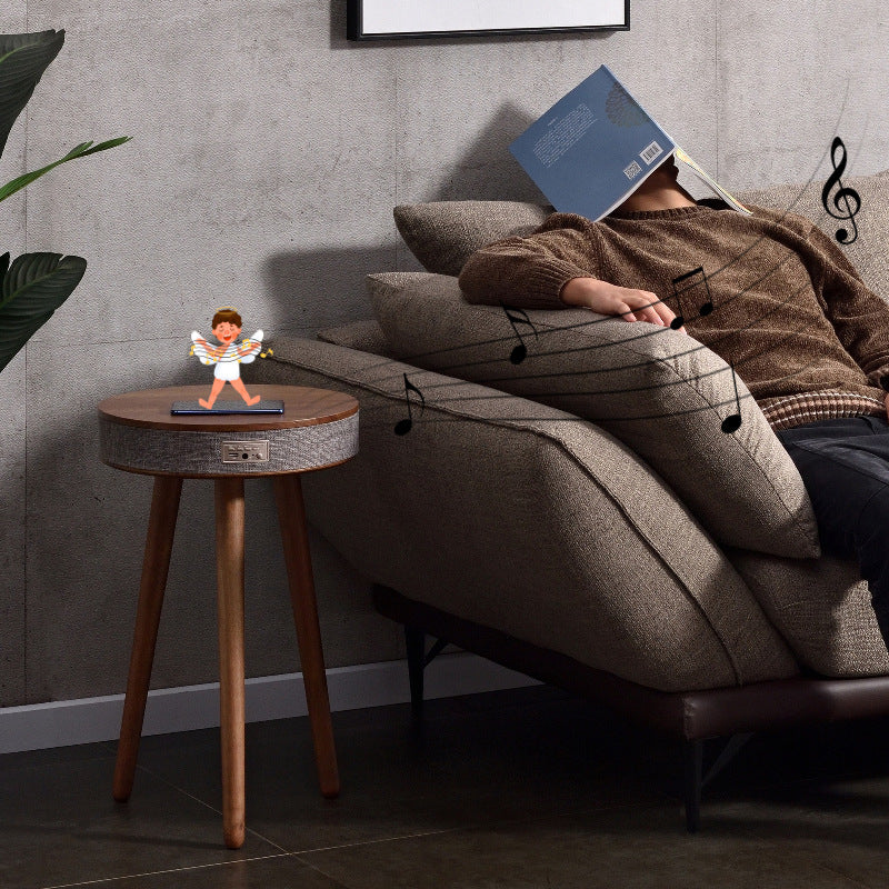 A modern round coffee table with built-in Bluetooth speaker and wireless charging for seamless living