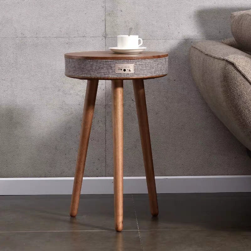 A modern round coffee table with built-in Bluetooth speaker and wireless charging for seamless living