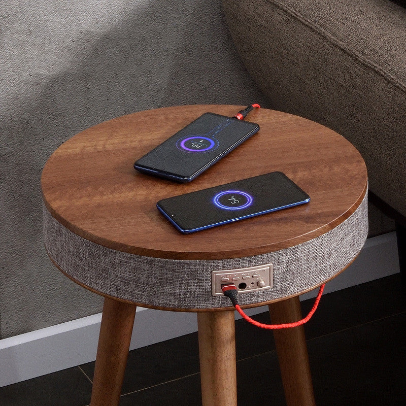 A modern round coffee table with built-in Bluetooth speaker and wireless charging for seamless living