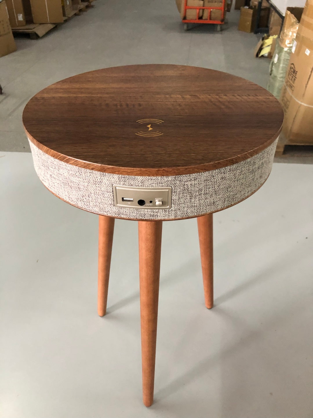 A modern round coffee table with built-in Bluetooth speaker and wireless charging for seamless living