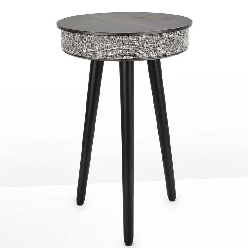 A modern round coffee table with built-in Bluetooth speaker and wireless charging for seamless living