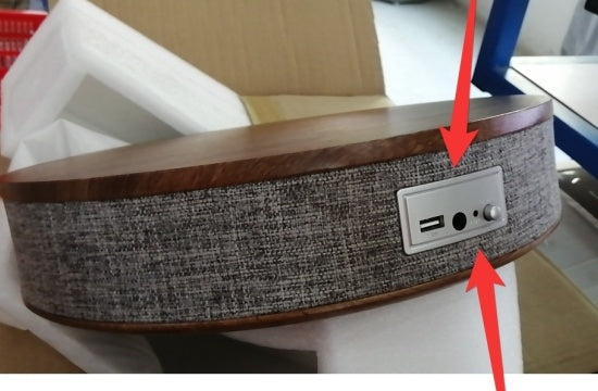A modern round coffee table with built-in Bluetooth speaker and wireless charging for seamless living