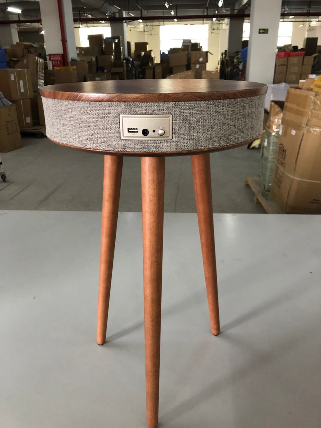 A modern round coffee table with built-in Bluetooth speaker and wireless charging for seamless living