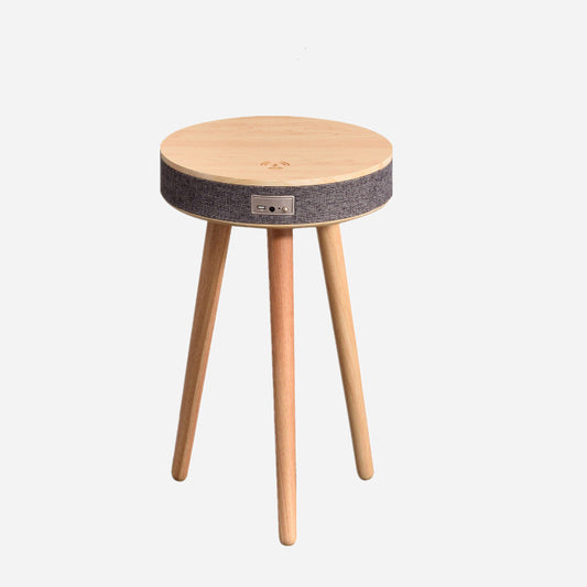A modern round coffee table with built-in Bluetooth speaker and wireless charging for seamless living