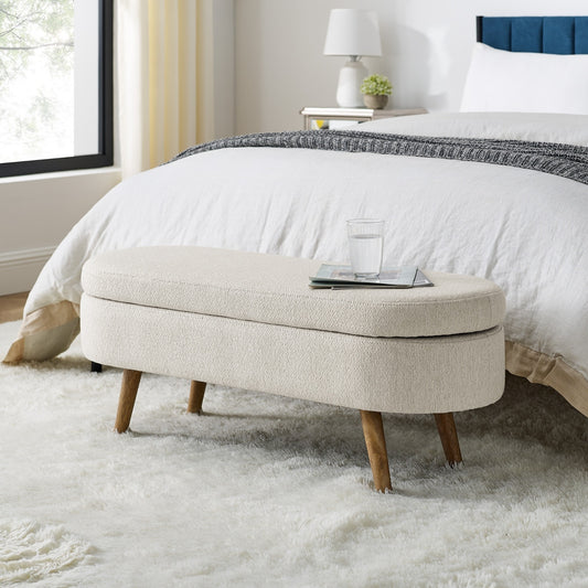 An elegant oval ottoman with hidden storage, crafted for timeless function and refined style