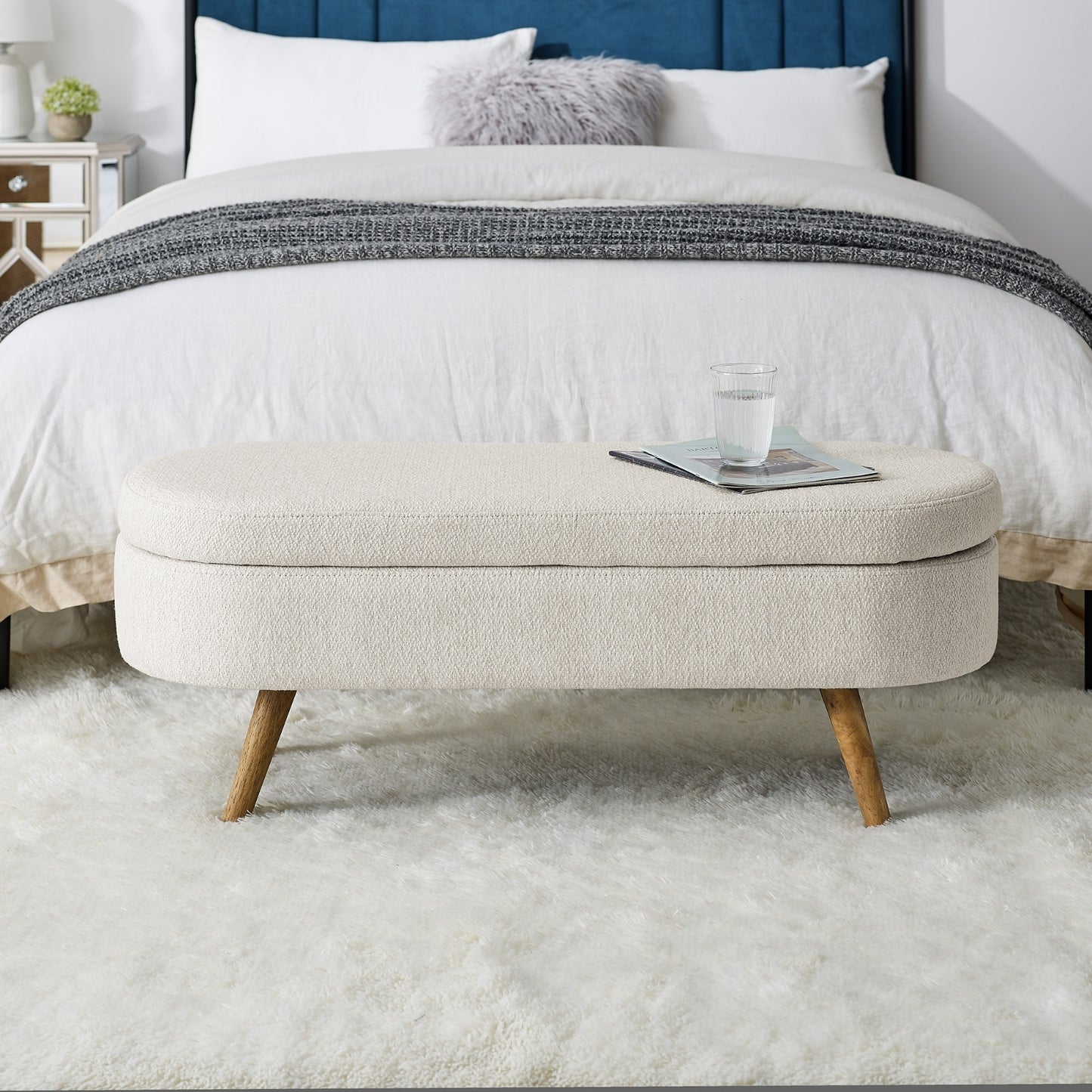 An elegant oval ottoman with hidden storage, crafted for timeless function and refined style